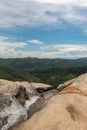 Young woman in a Sunny day in the Tropical waterfall falls from the mountain cliff to the jungle, serene landscape of Diyaluma fal Royalty Free Stock Photo