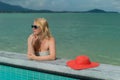 Young woman suntanning near pool Royalty Free Stock Photo