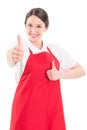 Young woman supermarket employee showing thumbs up