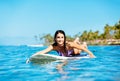 Young Woman Surfing with Her Dog