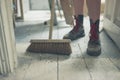 Young woman sweeping the floor Royalty Free Stock Photo