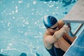 Young woman swimmer going to swim in swimming pool Royalty Free Stock Photo