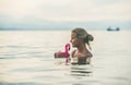 Young woman swimming with flamingo toy, Alanya, Turkey