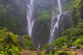 A young woman in swimming suit in front of Sekumpul Waterfall in Bali Island Royalty Free Stock Photo