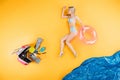 young woman in swimsuit and flip flops holding swimming ring on imagine beach, summer Royalty Free Stock Photo