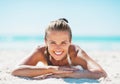 Young woman in swimsuit laying on sandy beacn Royalty Free Stock Photo