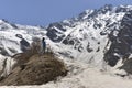 Young woman in t-shirt among snowy mountains