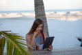 Young woman with tablet on the beach Royalty Free Stock Photo