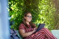 Young woman with tablet computer in the park