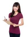 Young Woman take note on clipboard Royalty Free Stock Photo