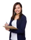 Young Woman take note on clipboard Royalty Free Stock Photo