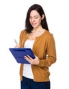 Young Woman take note on clipboard Royalty Free Stock Photo