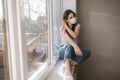 Young woman take off protective mask. Female in white t-shirt and white medical mask. End of quarantine. Coronavirus Royalty Free Stock Photo