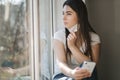 Young woman take off protective mask. Female in white t-shirt and white medical mask. End of quarantine. Coronavirus Royalty Free Stock Photo