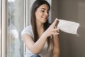 Young woman take off protective mask. Female in white t-shirt and white medical mask. End of quarantine. Coronavirus Royalty Free Stock Photo