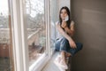 Young woman take off protective mask. Female in white t-shirt and white medical mask. End of quarantine. Coronavirus Royalty Free Stock Photo