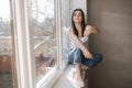 Young woman take off protective mask and throws out. Female in white t-shirt and white medical mask. End of quarantine Royalty Free Stock Photo