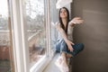 Young woman take off protective mask and throws out. Female in white t-shirt and white medical mask. End of quarantine Royalty Free Stock Photo