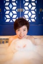 Young woman takes bubble bath Royalty Free Stock Photo