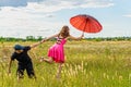 A young woman takes off with an umbrella, and a man holds her hand, levitation