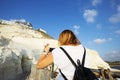 A young woman takes a photo with a mobile phone rosh hanikra, Israel Royalty Free Stock Photo