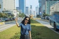 Young woman takes photo with Welcome statue