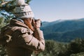 Young woman takes a photograph to the mountains Royalty Free Stock Photo