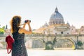 Young woman takes a picture of Cathedral of St. Peter in Rome Royalty Free Stock Photo