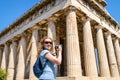 Young woman takes a picture of Temple of Hephaestus in Agora, At Royalty Free Stock Photo