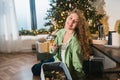 Young woman takes toys for the Christmas tree out of the box Royalty Free Stock Photo