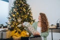 Young woman takes toys for the Christmas tree out of the box Royalty Free Stock Photo