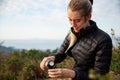 Young Woman Taking A Break From Countryside Hike And Pouring Coffee From Flask Royalty Free Stock Photo