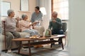 Young woman taking care of elderly people in room