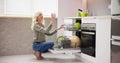 Young Woman Taking Drinking Glass From Dishwasher Royalty Free Stock Photo