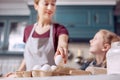 Young woman taking egg and chatting with daughter