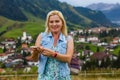 Young woman taking her smartphone in the alps. Royalty Free Stock Photo