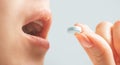 Woman taking a white round pill, view of mouth. Royalty Free Stock Photo