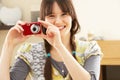 Young Woman Taking Photograph On Digital Camera