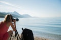 Young woman  taking photos of beautiful morning sea Royalty Free Stock Photo