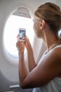 Young woman taking photos during flight Royalty Free Stock Photo