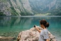 Young woman taking photos at beautiful and misty lake Royalty Free Stock Photo