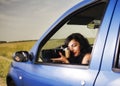 Young woman taking photos with telephoto lens