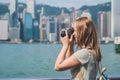 Young woman taking photos of victoria harbor in Hong Kong, China Royalty Free Stock Photo