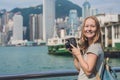 Young woman taking photos of victoria harbor in Hong Kong, China Royalty Free Stock Photo