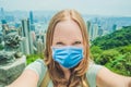 Young woman taking photos of victoria harbor in Hong Kong, China Tourists fear the 2019-ncov virus. Medical masked Royalty Free Stock Photo