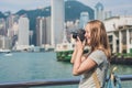 Young woman taking photos of victoria harbor in Hong Kong, China Royalty Free Stock Photo