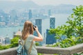 Young woman taking photos of victoria harbor in Hong Kong, China Royalty Free Stock Photo