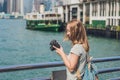 Young woman taking photos of victoria harbor in Hong Kong, China Royalty Free Stock Photo