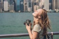 Young woman taking photos of victoria harbor in Hong Kong, China Royalty Free Stock Photo