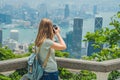 Young woman taking photos of victoria harbor in Hong Kong, China Royalty Free Stock Photo